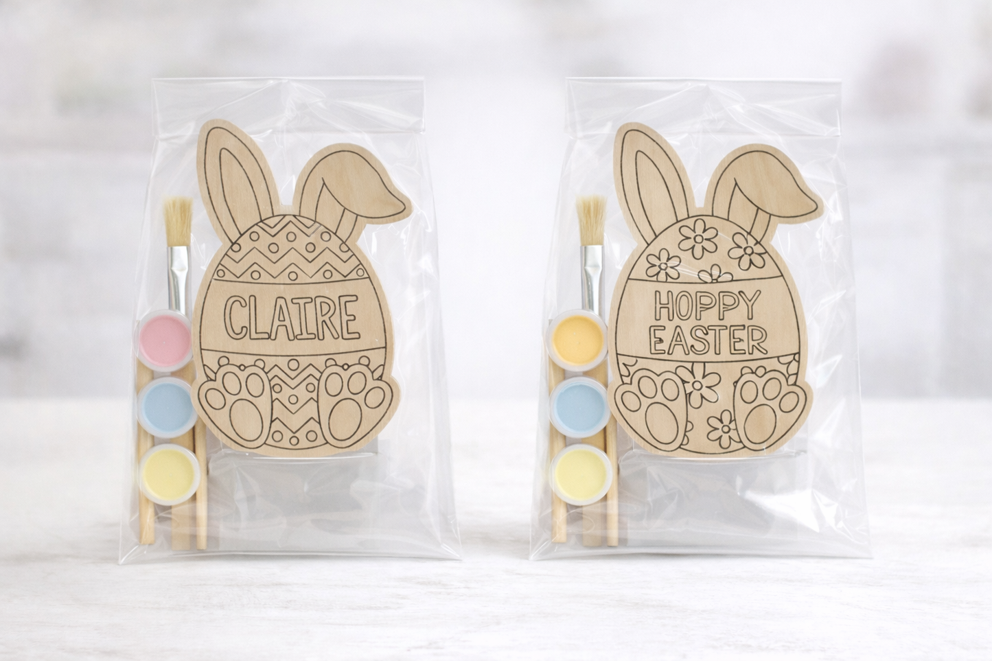 Child's personalized wooden bunny paint kit with three paint pots and a brush on a white background.