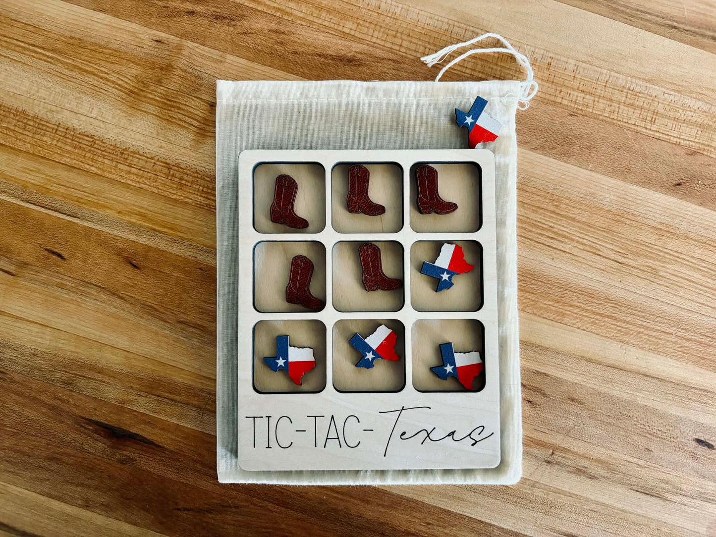 Compact travel-sized Texas game in a muslin storage bag for kids and travel.