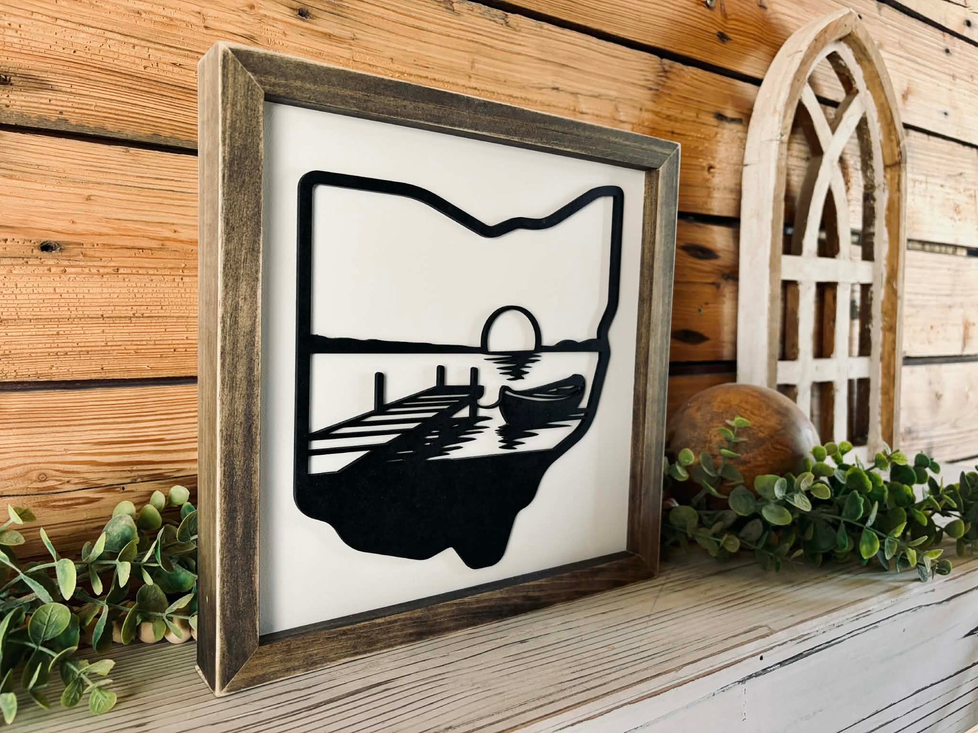 Modern farmhouse Ohio state wall art with a black state silhouette and white layered lake scene in a stained pine frame.