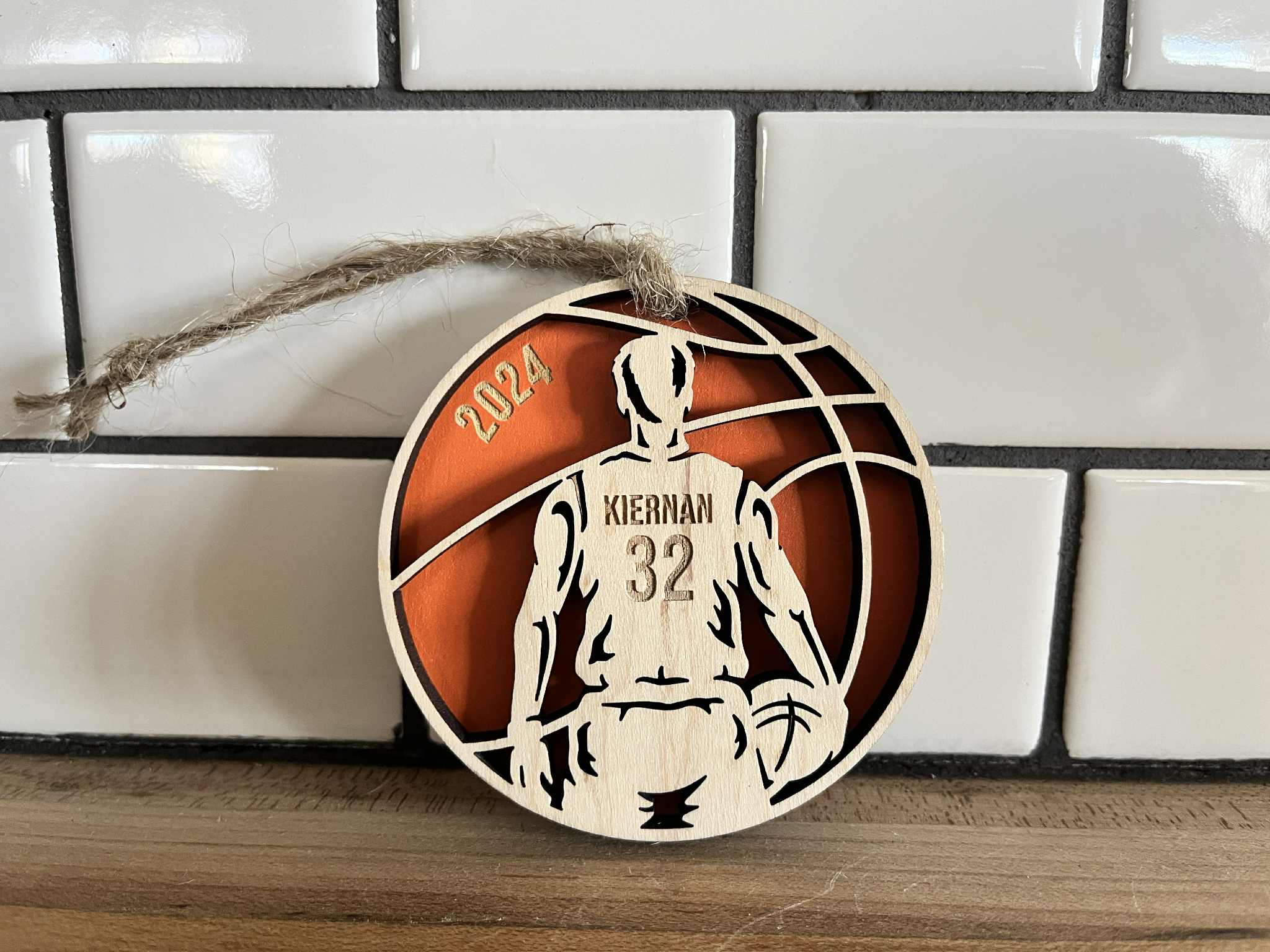3-inch round maple and MDF basketball ornament personalized with player name and number