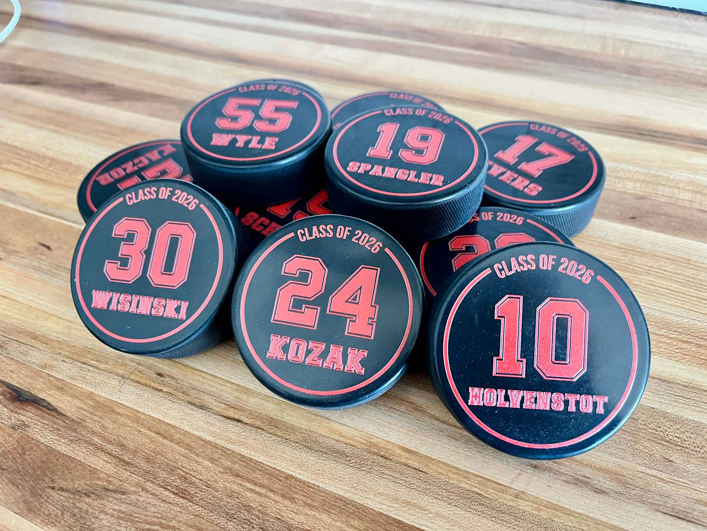 Official 6oz regulation rubber hockey puck with custom full-color logo printing.