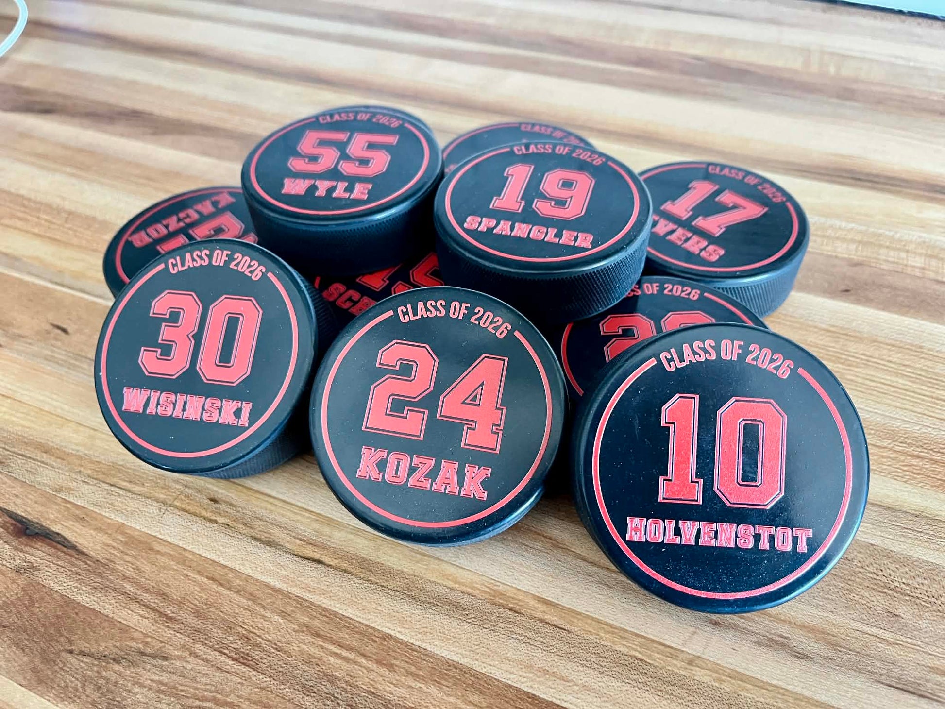 Official 6oz regulation rubber hockey puck with custom full-color logo printing.