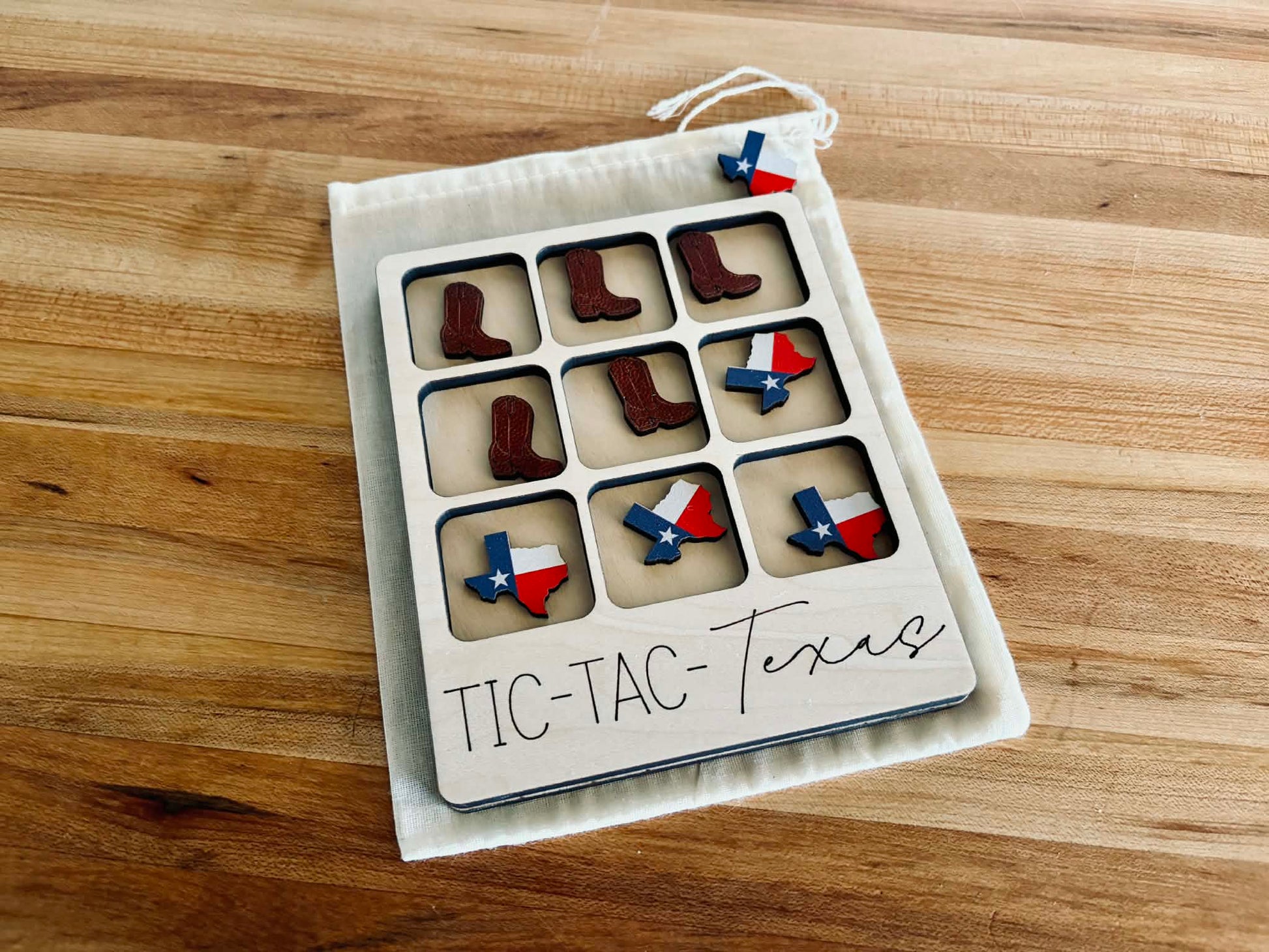 Compact travel-sized Texas game in a muslin storage bag for kids and travel.