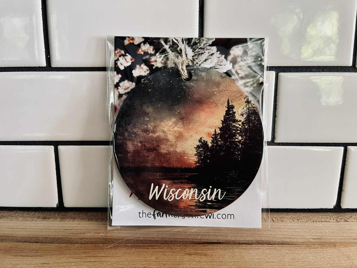Wisconsin sunset maple wood ornament with forest silhouette and jute cord