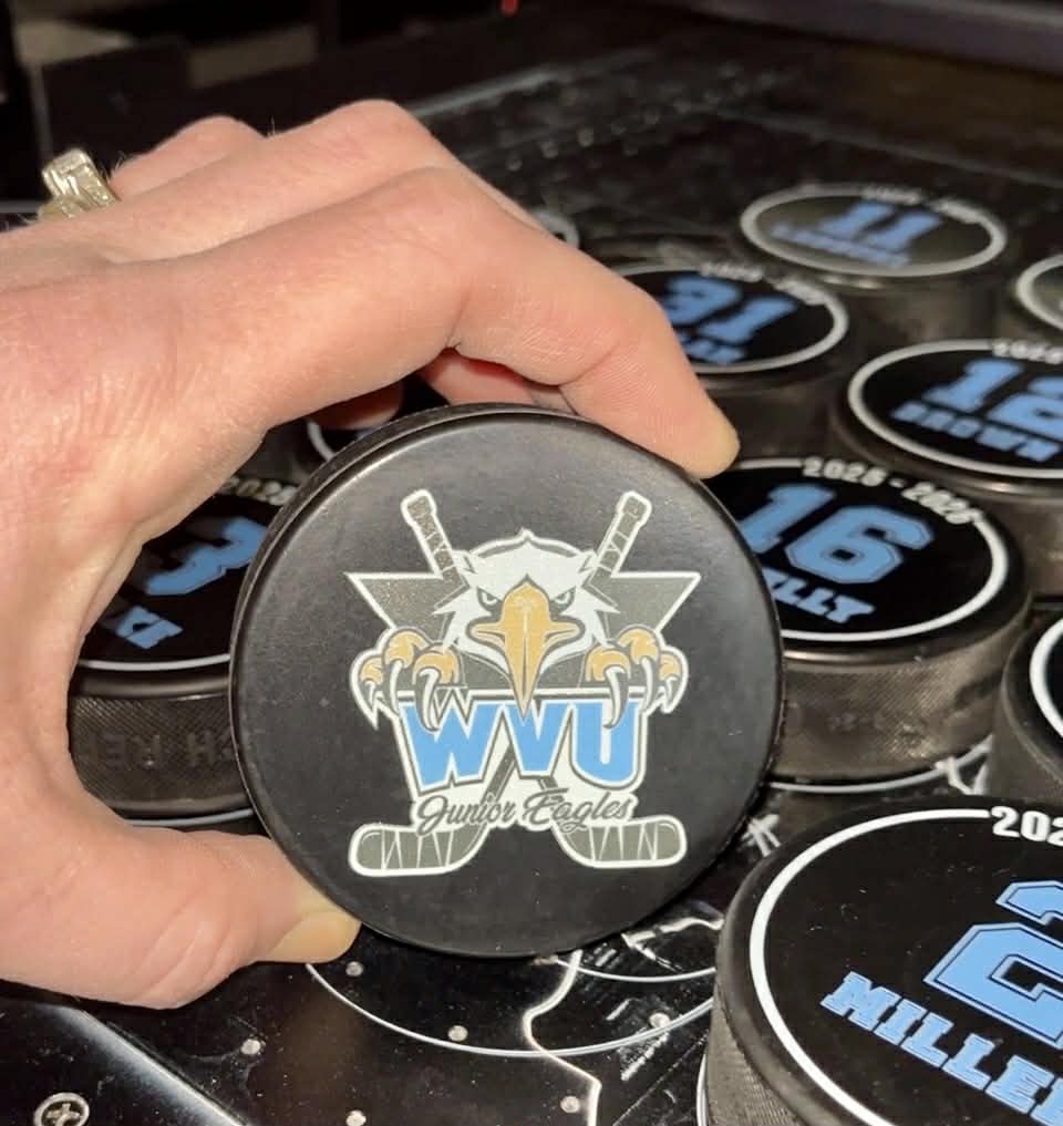 Custom double-sided hockey pucks with team logo on front and player name and number on back for senior gifts.