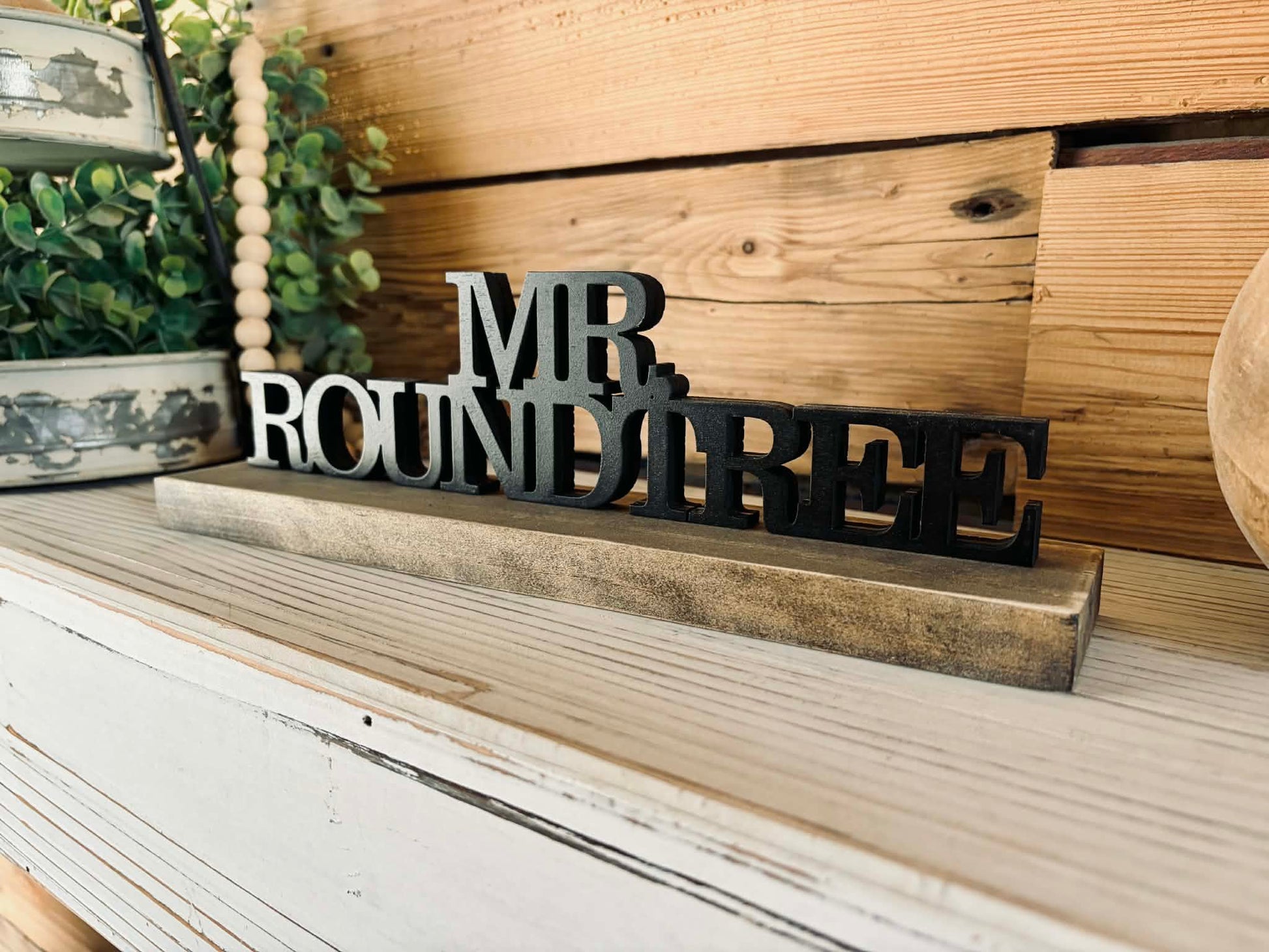 Hand-painted 3D wood desk name plate with raised black lettering for a teacher's desk.