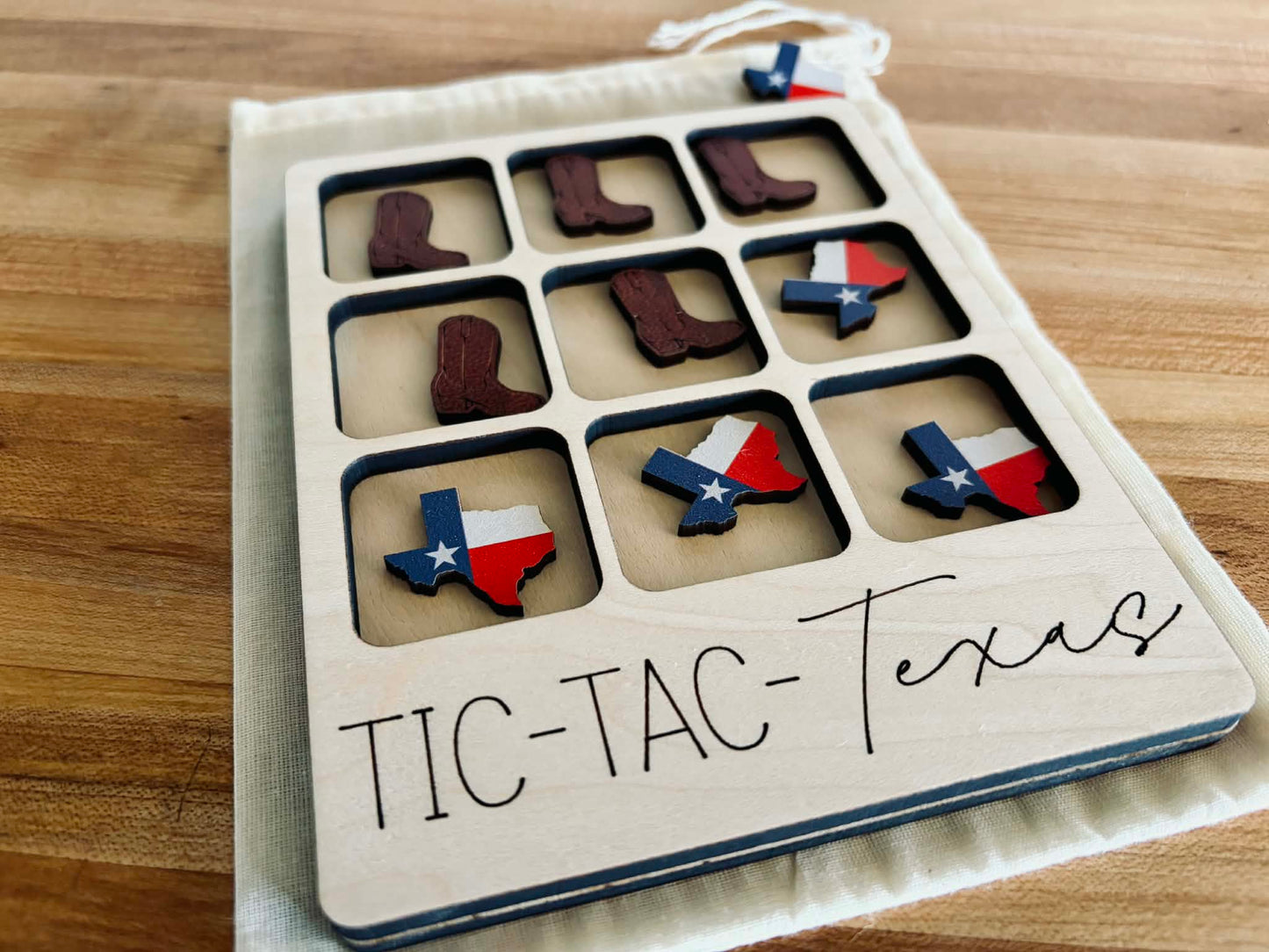 Handmade wooden Texas Tic Tac Toe board with Longhorn and Texas state shaped game pieces.