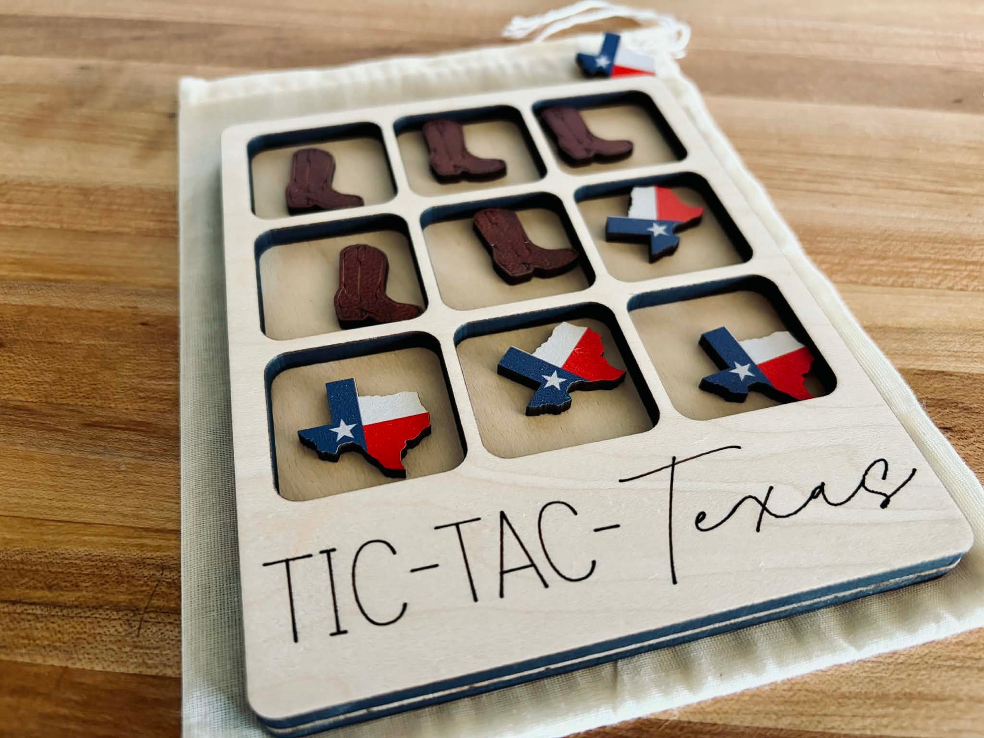 Handmade wooden Texas Tic Tac Toe board with Longhorn and Texas state shaped game pieces.