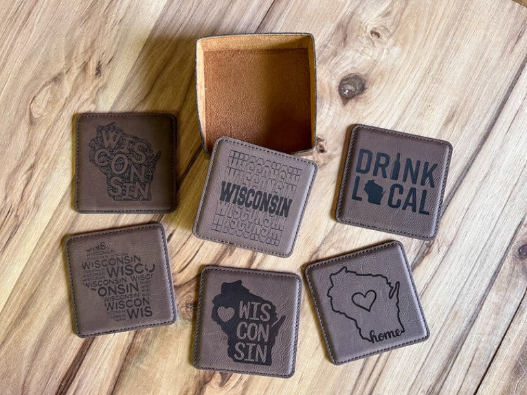 A offers set of six coasters in a holder. Natural bull leather. Wooden gift packaging. Perfect present for frends.